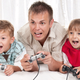 Illustration for article titled A Dad And His Kids Happily Play Video Games Together. They Have To.